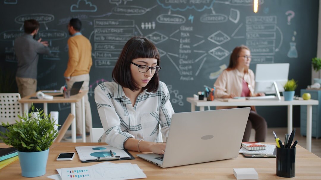 Startup team working on laptops in modern office