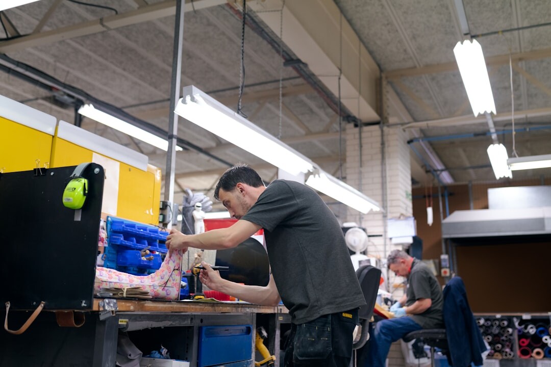 Group of students collaborating around a laptop in a workshop