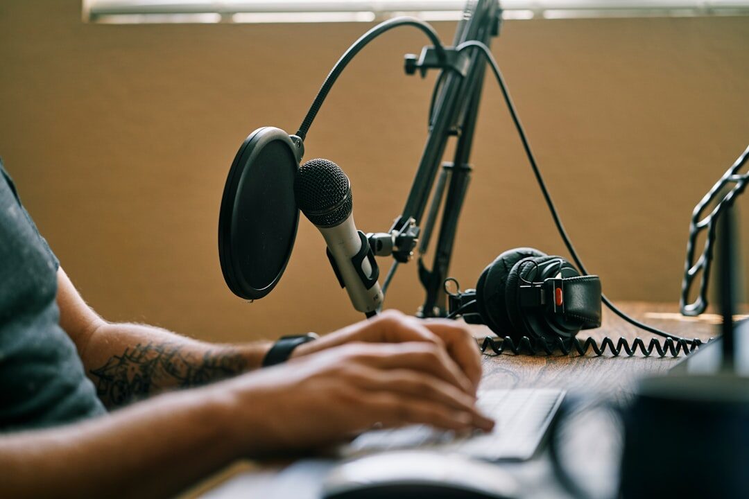 Podcast microphone setup on a desk in a recording studio